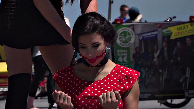 Kinky tattooed brunette sub gagged and humiliated by her domme in public