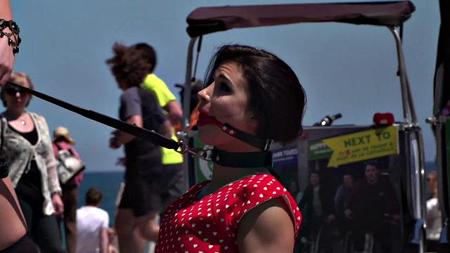 Kinky tattooed brunette sub gagged and humiliated by her domme in public