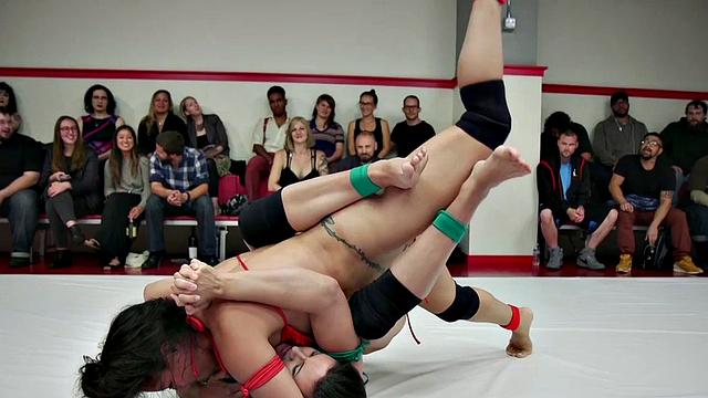 Group of amateur wrestlers perform their fight in public