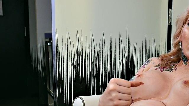 Busty trans beauty tweaks her nipples and tugs cock