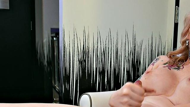 Busty trans beauty tweaks her nipples and tugs cock
