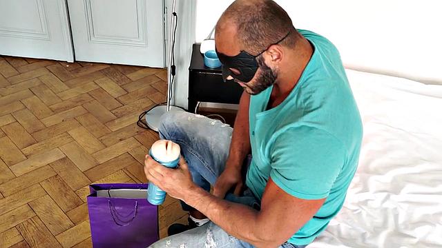 Masked athletic hunk wanks cock with sex toy and cums