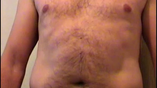 rugged bearded stud strips down and strokes his thick cock for the camera
