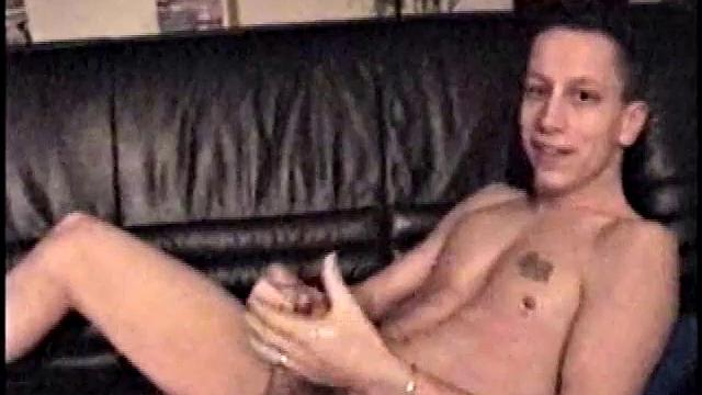 Kicking back on the couch, Dominic mugs a little for the camera while he flips through some porn mags for inspiration. He's pretty chatty at first, but gets quieter as he admires his hardening dick and starts stroking it.