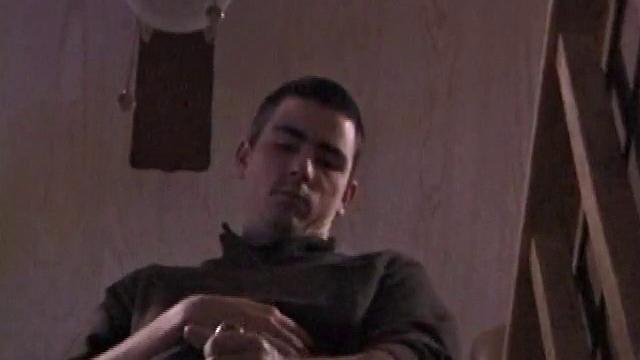 By the time the camera finds him, Dan is already going for his woody. He seems uncomfortable in the chair, so he stands up and moves to the staircase, where we can see his cock getting harder and harder.