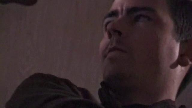 By the time the camera finds him, Dan is already going for his woody. He seems uncomfortable in the chair, so he stands up and moves to the staircase, where we can see his cock getting harder and harder.