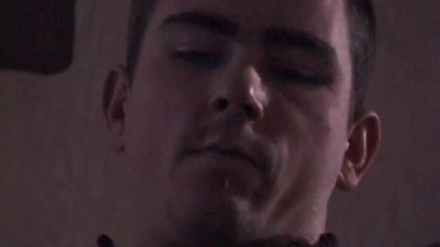 By the time the camera finds him, Dan is already going for his woody. He seems uncomfortable in the chair, so he stands up and moves to the staircase, where we can see his cock getting harder and harder.