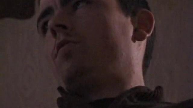 By the time the camera finds him, Dan is already going for his woody. He seems uncomfortable in the chair, so he stands up and moves to the staircase, where we can see his cock getting harder and harder.