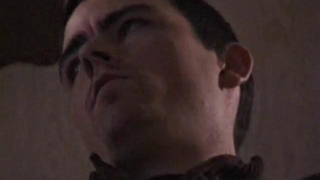 By the time the camera finds him, Dan is already going for his woody. He seems uncomfortable in the chair, so he stands up and moves to the staircase, where we can see his cock getting harder and harder.