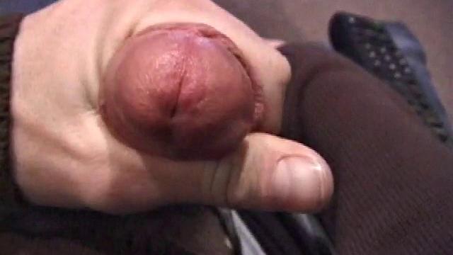 By the time the camera finds him, Dan is already going for his woody. He seems uncomfortable in the chair, so he stands up and moves to the staircase, where we can see his cock getting harder and harder.