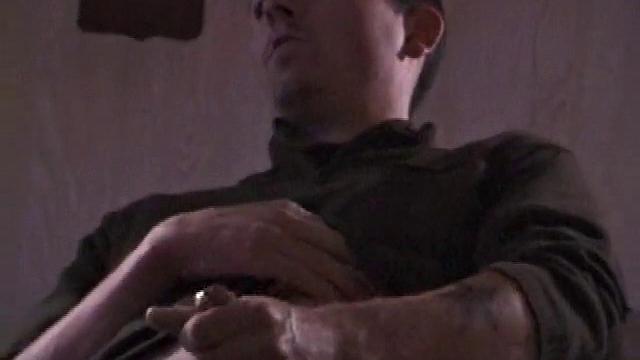 By the time the camera finds him, Dan is already going for his woody. He seems uncomfortable in the chair, so he stands up and moves to the staircase, where we can see his cock getting harder and harder.