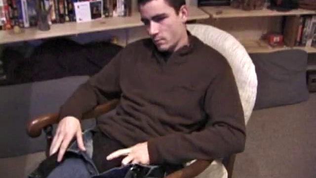 By the time the camera finds him, Dan is already going for his woody. He seems uncomfortable in the chair, so he stands up and moves to the staircase, where we can see his cock getting harder and harder.