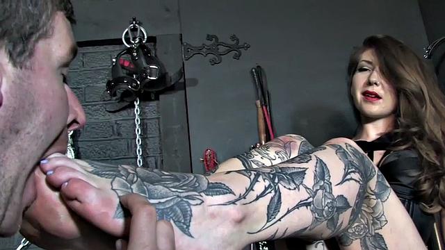 Pathetic loser licks feet of scratching domina in BDSM
