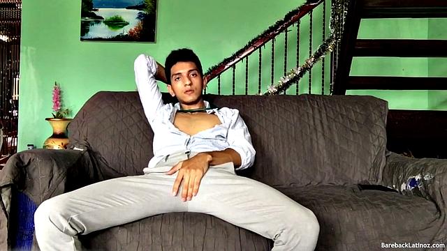 On a sofa, Santiago slowly strips down and pulls his big uncut cock out. The slim Latino never gets completely naked, as he beats off with determination.