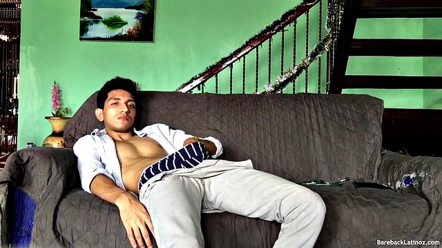 On a sofa, Santiago slowly strips down and pulls his big uncut cock out. The slim Latino never gets completely naked, as he beats off with determination.
