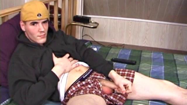 Relaxed on the bed, Timmy unzips his jeans and pulls out his cock. He strokes to the porn video he's watching. After edging himself a few times, the young man spills a messy cum load onto his stomach.