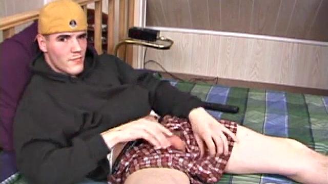 Relaxed on the bed, Timmy unzips his jeans and pulls out his cock. He strokes to the porn video he's watching. After edging himself a few times, the young man spills a messy cum load onto his stomach.