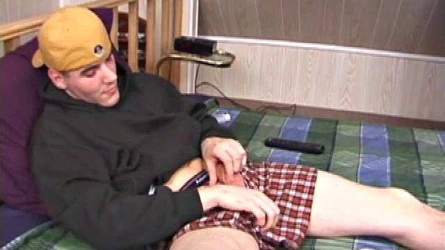 Relaxed on the bed, Timmy unzips his jeans and pulls out his cock. He strokes to the porn video he's watching. After edging himself a few times, the young man spills a messy cum load onto his stomach.