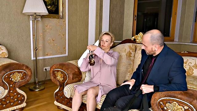 Blonde mature with glasses fucks in living room while wearing socks