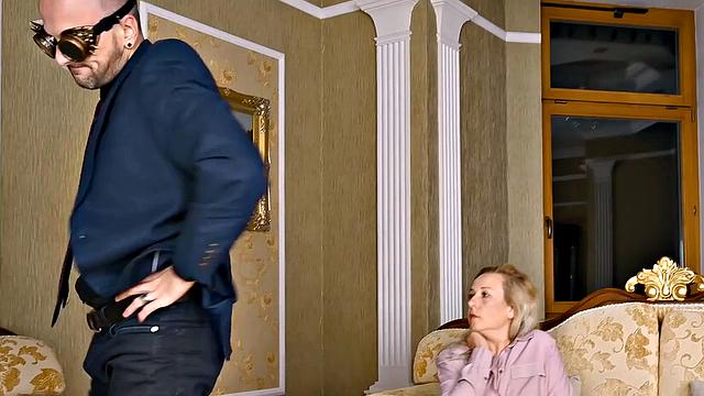 Blonde mature with glasses fucks in living room while wearing socks