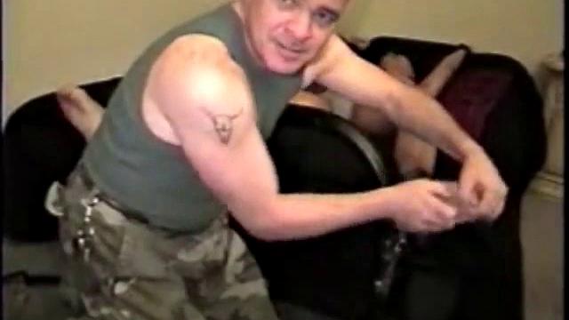 Agent Mike strips captured spy, carries him to the rack and straps him down for interrogation.