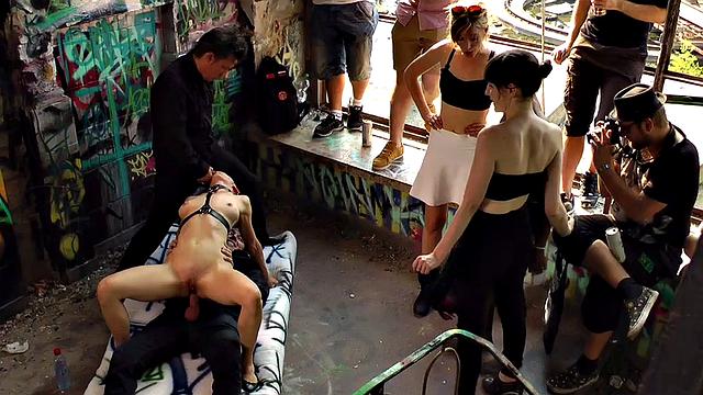BDSM babe anally drilled and spanked by crowd in public