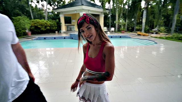 Latina cheerleader in skirt and sneakers enjoys a wild outdoor fuck session