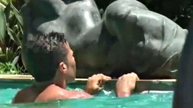 Ramon is alone in the pool doing power laps when Rodrigo jumps in. The two big dicked muscle hunks affectionately pose, and kiss, before moving behind a hidden statue nook.