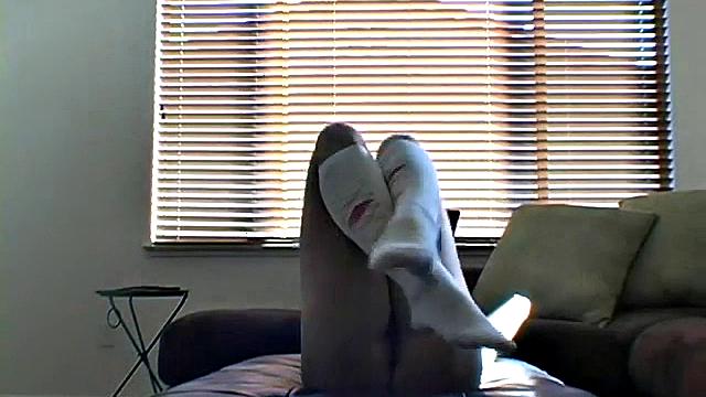 Stripteasing teen opens her skinny legs wide