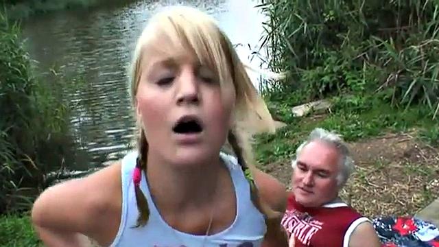 Young blonde teen gets down & dirty with an older guy in public