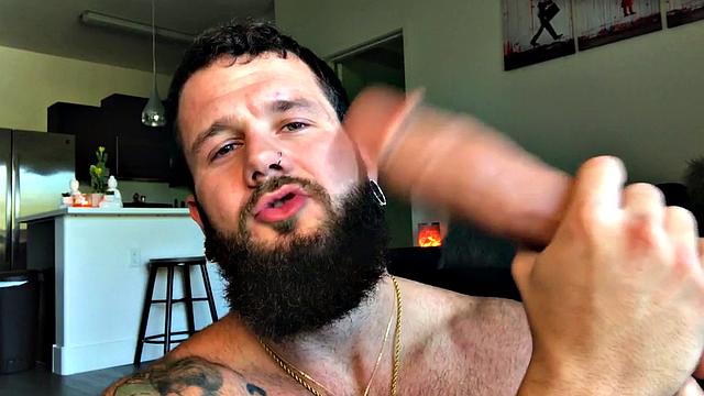 Bearded jock rides huge dildo while masturbating