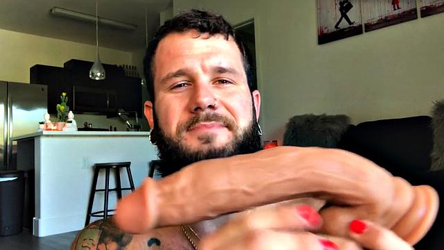 Bearded jock rides huge dildo while masturbating