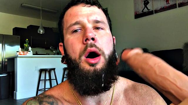 Bearded jock rides huge dildo while masturbating