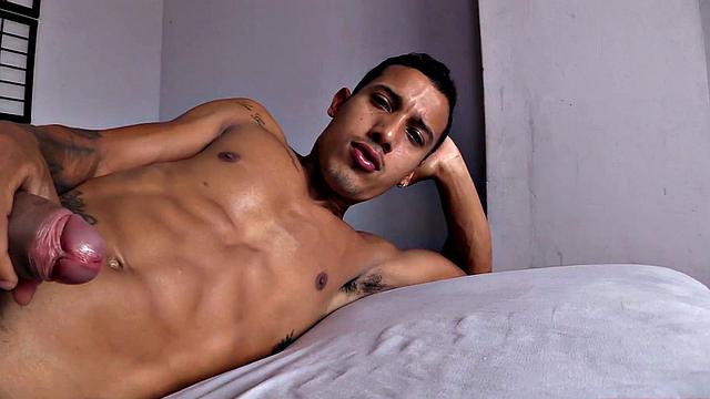 Already stripped to his underwear, it isn't long before this Latino is naked on a bed and working up a stiff one.