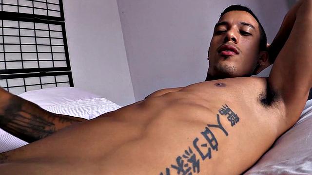Already stripped to his underwear, it isn't long before this Latino is naked on a bed and working up a stiff one.