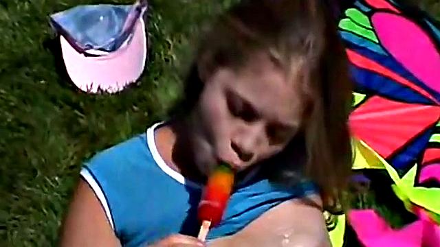 Little April sucking on a popsicle