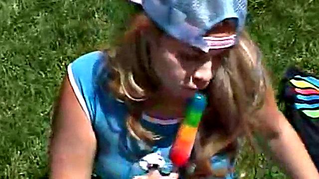 Little April sucking on a popsicle