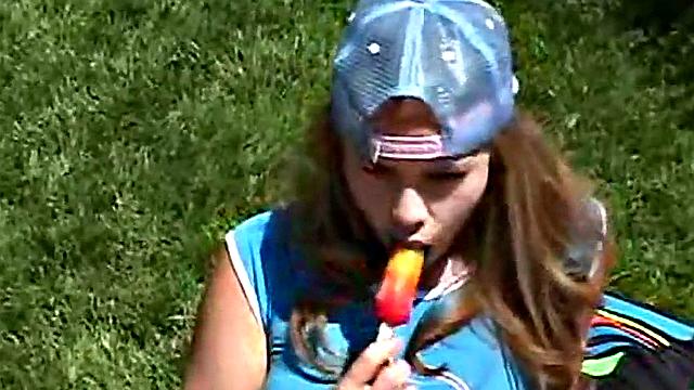 Little April sucking on a popsicle