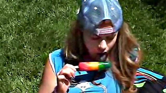 Little April sucking on a popsicle