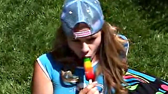 Little April sucking on a popsicle