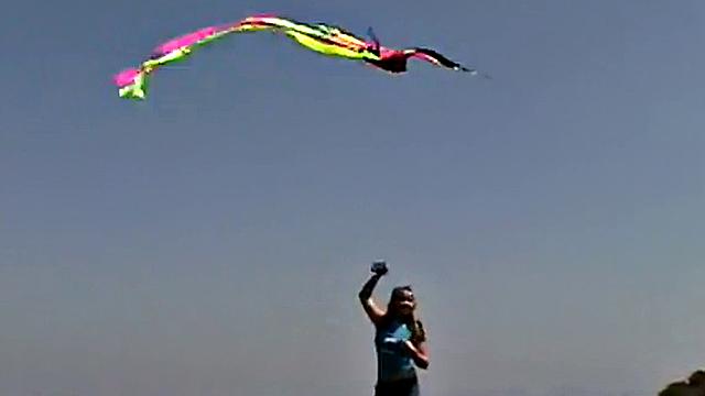 Little April sucking on a popsicle