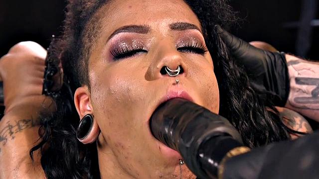 Bound subject toyed with dildo during punishment