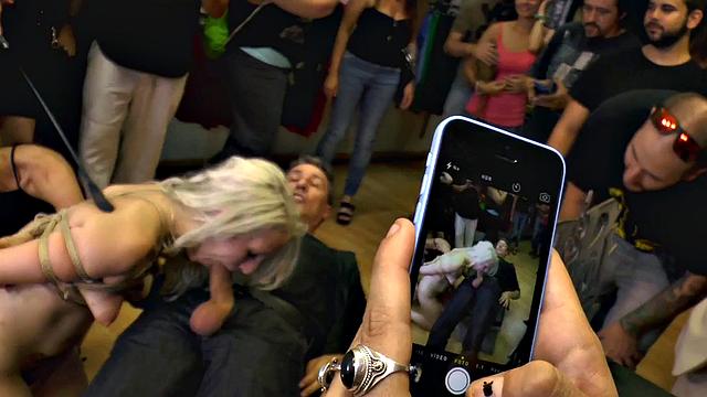 Bound public slut rides dick in crowded group