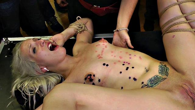 Bound public slut rides dick in crowded group