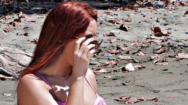 A bald chick get her pussy licked and fucked on the beach by her BF while wearing glasses