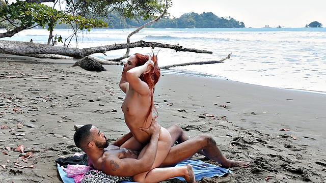 A bald chick get her pussy licked and fucked on the beach by her BF while wearing glasses