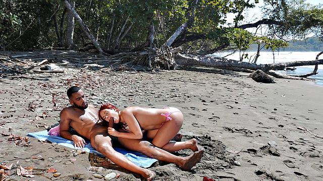 A bald chick get her pussy licked and fucked on the beach by her BF while wearing glasses