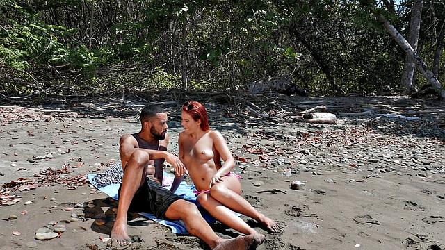 A bald chick get her pussy licked and fucked on the beach by her BF while wearing glasses