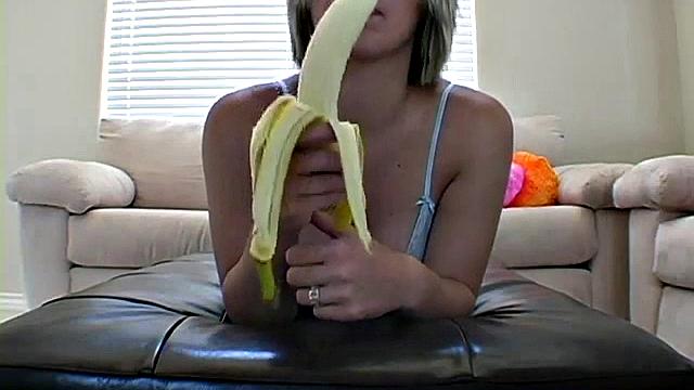 Teasing teen peels banana