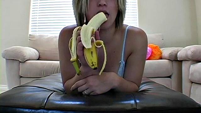 Teasing teen peels banana